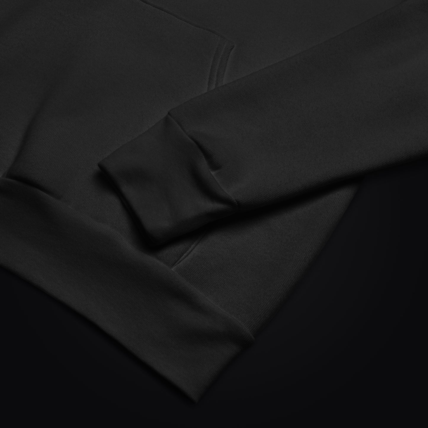 Close-up of black midweight fleece fabric and cuff detail on Cat Cult Coffee hoodie.